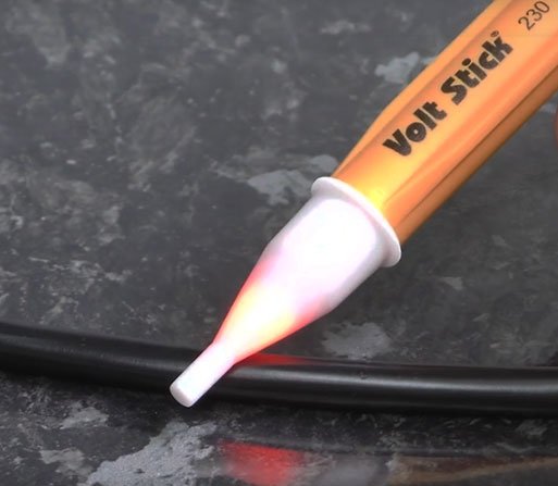 volt stick 230y testing on the flex of electrical appliance closer to the live